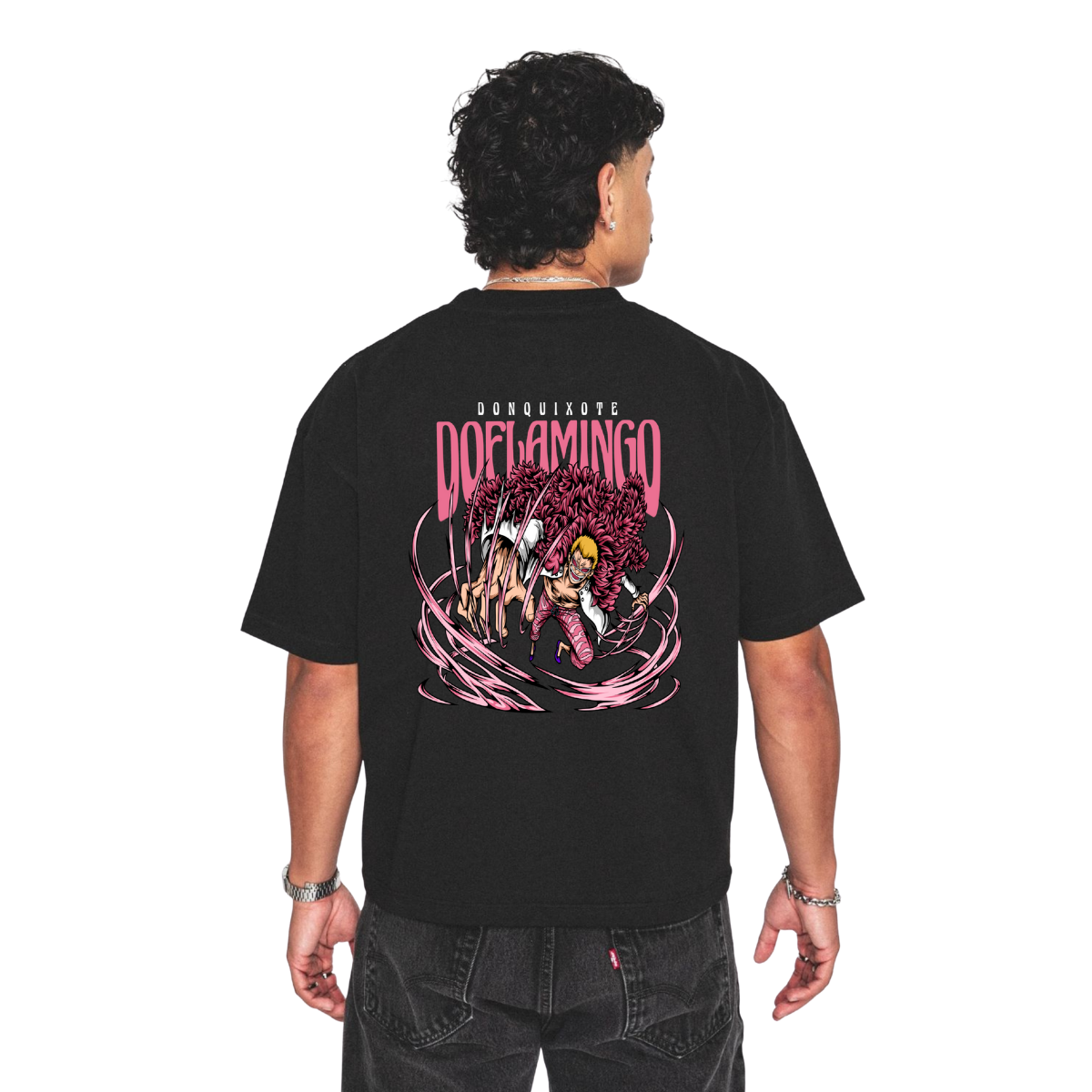 Person wearing a Donquixote doflamingo black t-shirt with a colorful graphic design on the back, set against a white background.