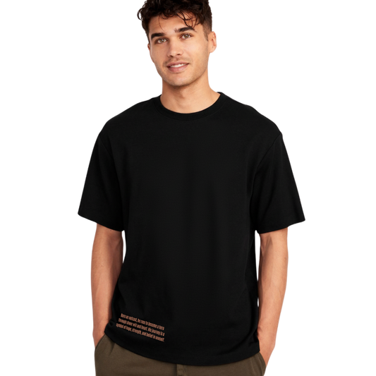 Young man wearing black ASDK short sleeve T-shirt with motivational text near hem